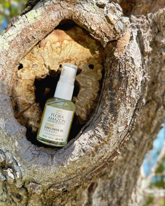 ozone sunflower oil sitting on a tree, a flora amazon secret for hair and skin health.