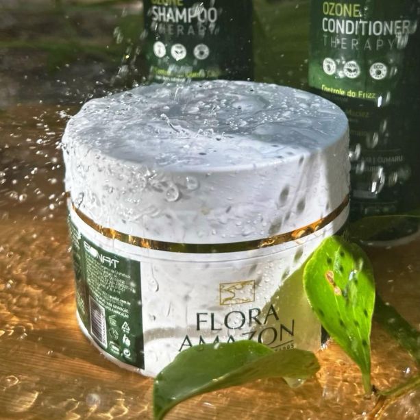 hair mask by flora amazon with ozone conditioner and shampoo behind it in a natural rainy scene.